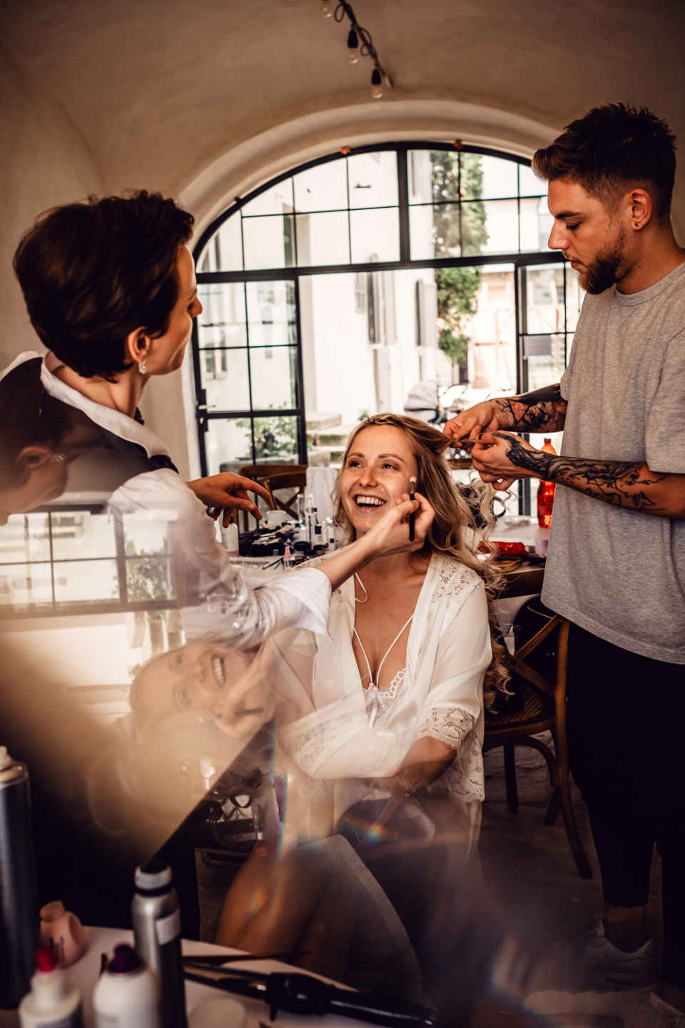 Getting the hair and makeup done is a fairly elaborate process, so you should wear something comfortable like a super-smooth silk robe.