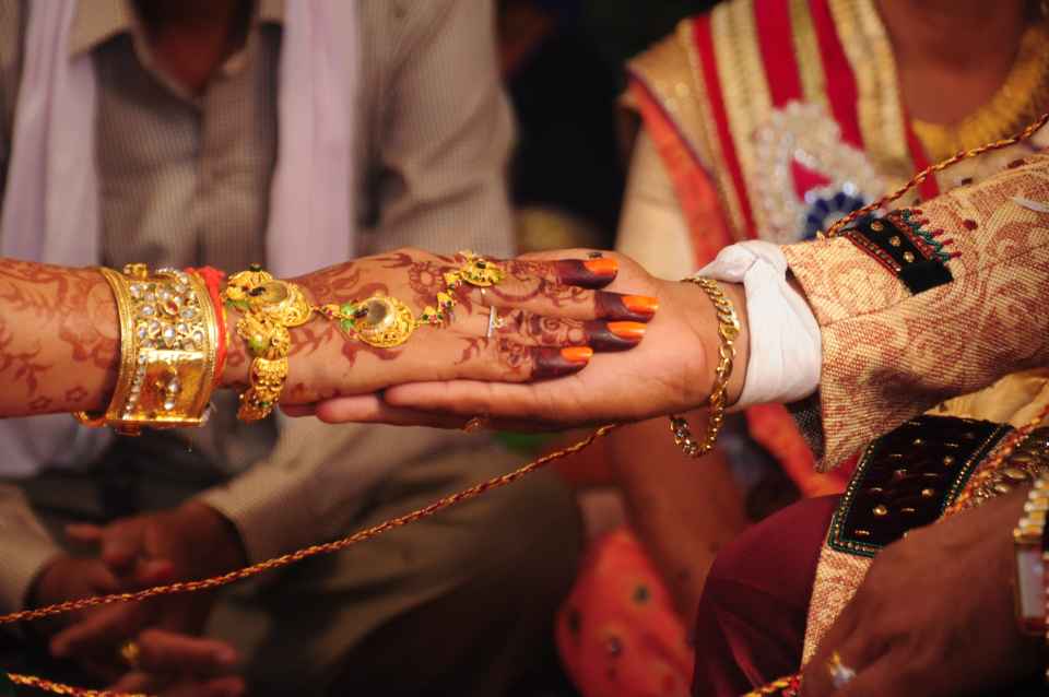 Under a wedding mandap, the main wedding ritual begins